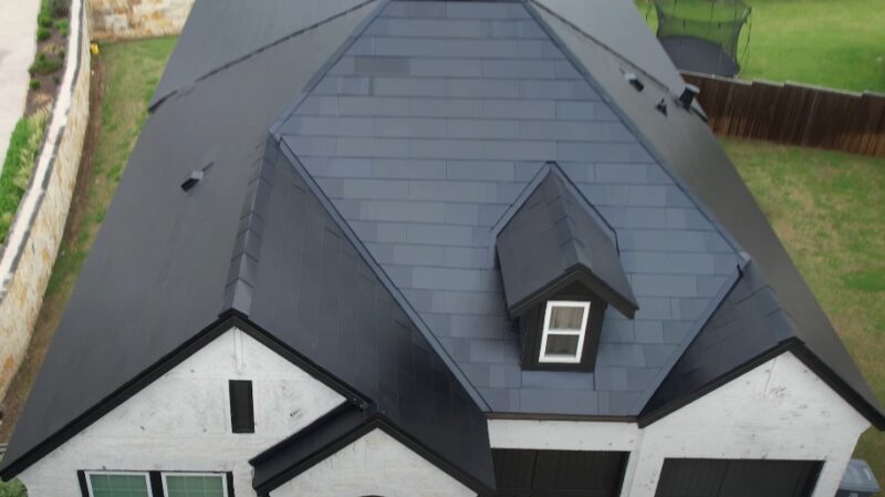 Modern, dark gray roof tiles cover the home's pitched structure