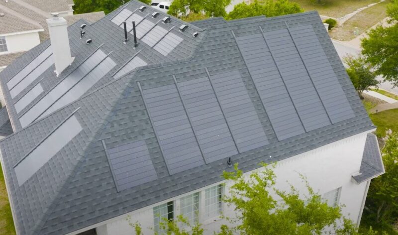 Integrated solar panels seamlessly blend with the gray shingle roof