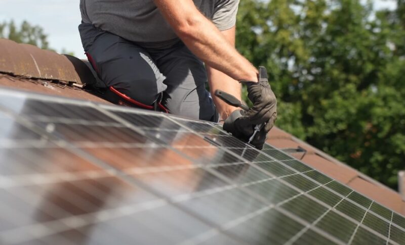 Man fixing solar roof panel